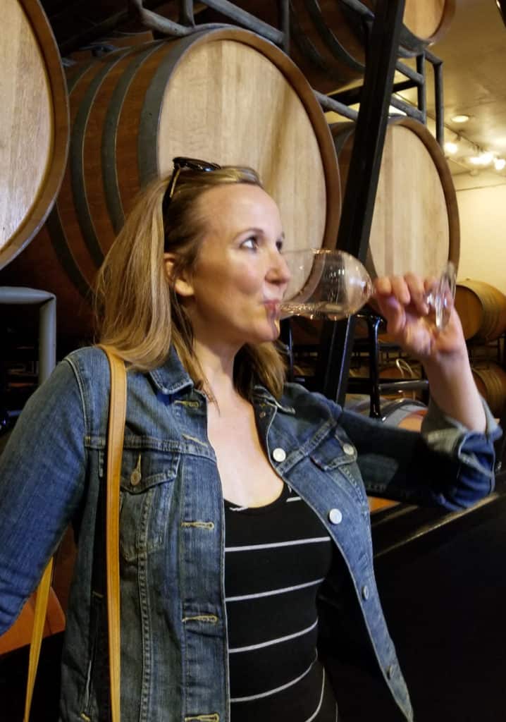 Santa Barbara Urban Wine Trail - woman drinking wine in front of wine barrels